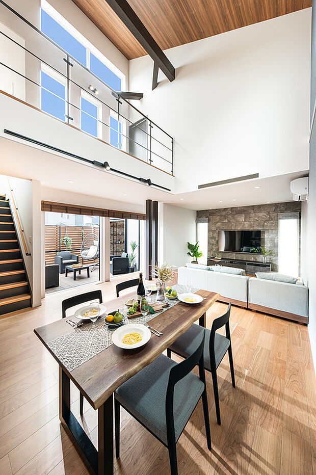 大きな吹抜けリビング。高窓からの陽光がLDKを明るく照らし開放感を感じる空間に。