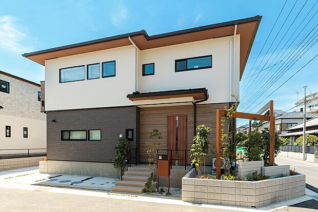 【建物完成】木目調と石目調、異なるテクスチャーを持つ外壁材の組み合わせと、直線で構成された端正なシルエットが融け合いったナチュラルモダンな景観を創出。優美さとぬくもりを感じる街並みがご家族をお迎えします。※モデル