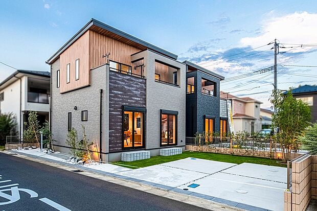 【建物プラン例　（外観写真）】【施工例住協建設】異素材が織りなす洗練のファサード。 温もりのある木目パネルとグレーのコントラスト。開放的なテラスが暮らしに彩りを添えるデザイン住宅。
