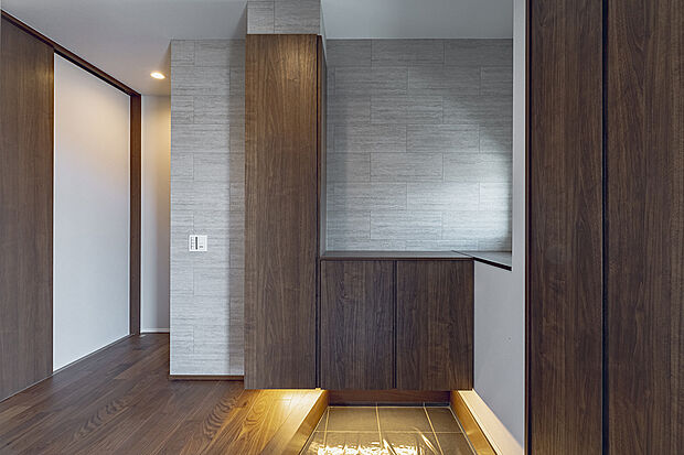 【玄関(2号棟)】おしゃれな雰囲気を演出する間接照明付きの玄関。家族や来客を心地よく迎えます。