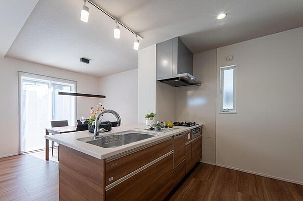 【【施工例/キッチン】】調理中もご家族との会話が弾む、対面式キッチン。木目調×白のワークトップでまとめた、スタイリッシュなデザインです。タッチレス水栓や食洗機など、機能も充実しています。