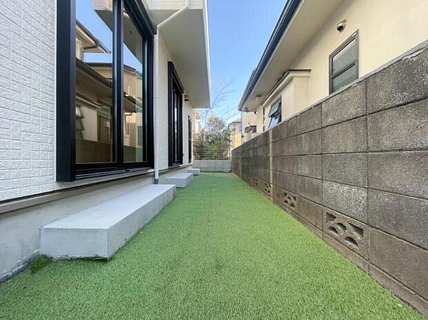 お庭には人工芝を敷設。一年中美しい緑を楽しめるだけでなく、草むしりの手間が省けるため、忙しい共働きファミリーにも嬉しい仕様です。泥跳ねの心配が少なく、お子様の遊び場としても最適です。