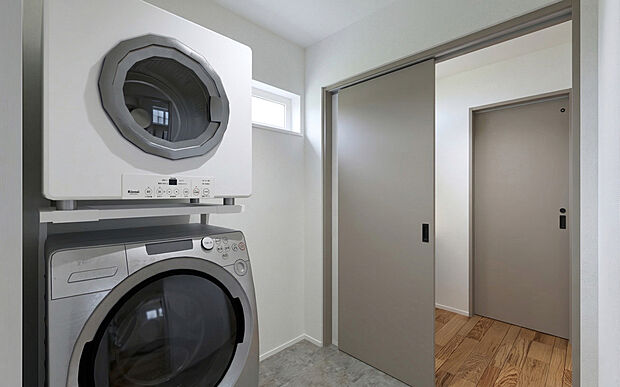 【No.2　脱衣所】洗面室と脱衣所を分けたセパレート仕様を採用し、ご家族が同時に気兼ねなく使用できるプライバシーに配慮した設計です。脱衣所内には、洗濯機やガス衣類乾燥機をスッキリと設置できる専用スペースを確保。