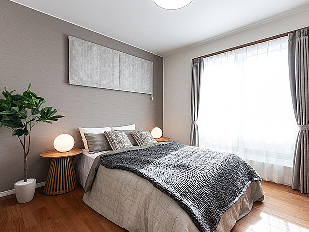 【主寝室 施工例】7.5帖の寝室には大型クローゼットがあり、たっぷり収納可能。2面の窓から快適な光を取り入れ、通気性能を上げる事で居心地の良い空間を演出します。一部アクセントクロスが入ります。