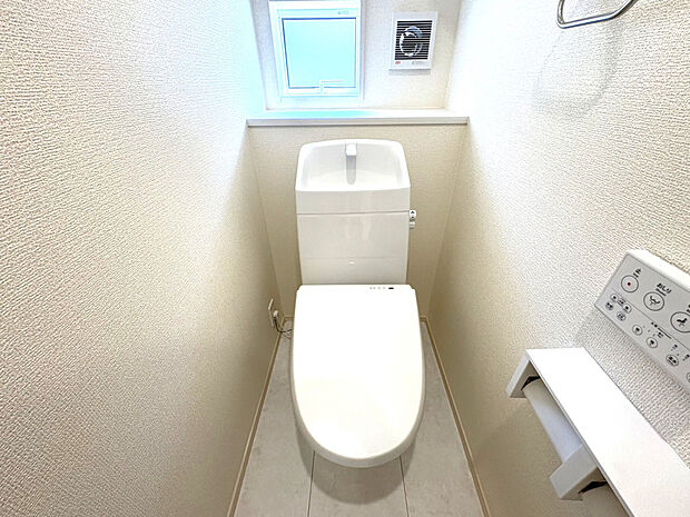 【トイレ　(2)号棟】シンプルで清潔感のあるトイレ空間。暮らしに寄り添う快適な設備仕様です。