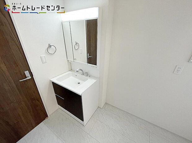 【洗面台・洗面所】３号棟
白を基調とした爽やかなサニタリースペース。清潔感のある快適空間です。毎日の身支度も気持ち良くお使い頂けます！洗面台は三面鏡となっておりますので、横顔チェックもバッチリですね！