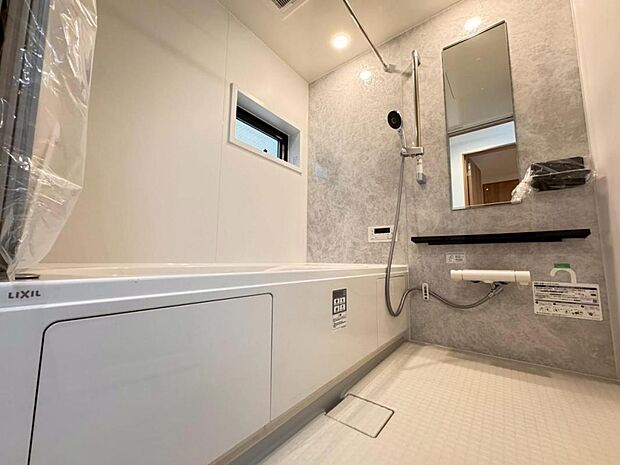 【バスルーム】一日の疲れを癒すバスルームは広々一坪タイプ。足を伸ばしてゆったりと浴槽に浸かっていただけます。雨の日や花粉の時期のお洗濯に最適な浴室換気乾燥機能もございます。