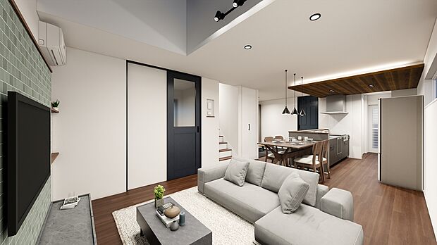 淡いグリーンのアクセント壁とブラックの建具が空間を引き締めるLDK。キッチンまで見渡せ、家族の気配を感じながら過ごせます。