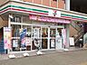 周辺：セブンイレブン 日野高幡不動駅前店 (1070m)