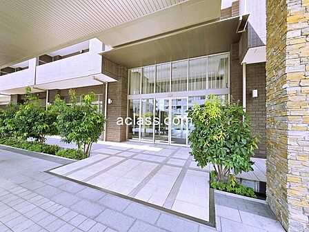 大きな庇に壁面には自然石を設えた、大規模マンションならではの堂々とした佇まいのグランドエントランスです。ホテルのような贅沢な設えです。
