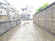 周囲の街並みと調和する、日々の暮らしの基点として落ち着きを感じさせる敷地内へのアプローチです。