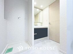 「清潔な印象の洗面室」明るく清潔感のある色調で纏められた洗面室は、機能性に富んだ三面鏡と使い勝手の良い収納を完備した洗面台を設置。洗濯機置場も完備し、大変充実しております。