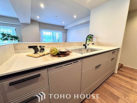 【Kitchen】美しく使いやすいキッチンは油汚れが簡単に拭き取れる素材で加工されており、浄水器シャワーから流す水の音を軽減する静かなシンクを採用。見えないところにさり気ない配慮が嬉しい