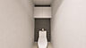 その他：コンクリート調アクセントクロスを採用した、シンプルながら上質感のあるトイレ空間。白を基調とした設備とのコントラストが美しく、アッパーキャビネットを設置することで収納力も確保。（内装完成予想図）