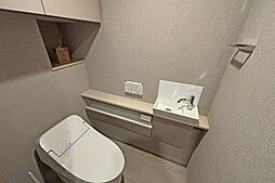 【トイレ】トイレには手洗い場がついています。ウォシュレット付で機能面もばっちりです。上部には収納棚があり掃除用具もすっきり収納可能です。
