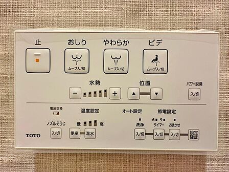 トイレの壁面にすっきりと収まる機能的な温水洗浄便座のリモコン。