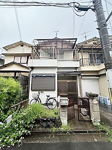 外観：落ち着いた住宅街に位置する外観が印象的です。門扉とポストが整然と配置されており敷地内には自転車スペースも確保されています。バルコニーやテラスのある構造が特徴の住まいです。