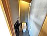 トイレ：間接照明と突板天井が雰囲気を演出するトイレスペース。