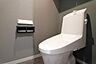 トイレ：シンプルで清潔感のあるトイレ空間です。落ち着いた色合いの壁紙が特徴です。収納も設置されており機能的な設備が整っています。快適なトイレ環境が整っています。