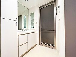 [洗面] 大きな鏡が特徴的な洗面室です。リネン収納は高さのある物を設置し、バスタオルや洗剤などの収納に役立ちます。